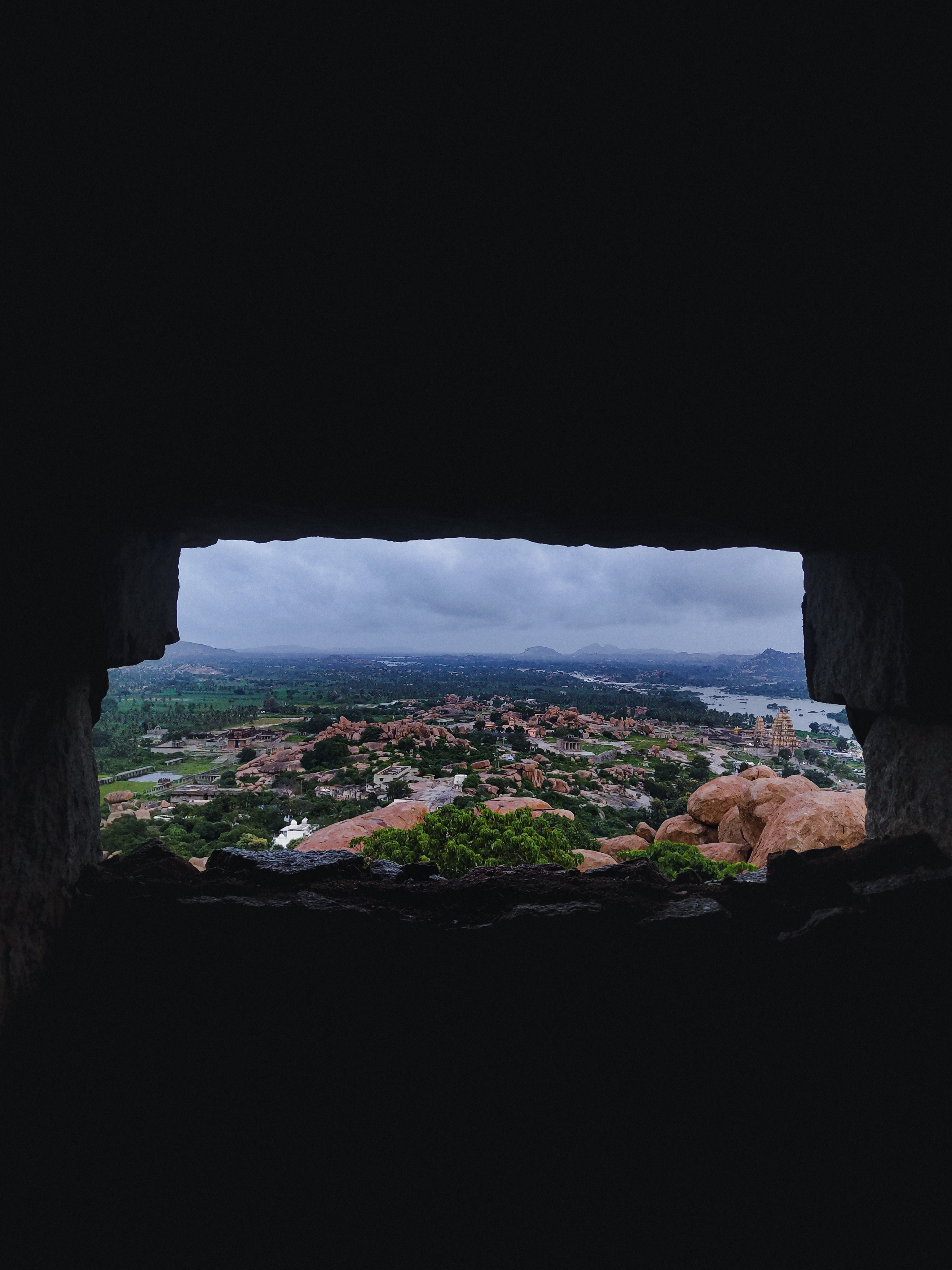 {Framed by shadows, the ancient temple emerges in golden light—a masterpiece of nature and architecture united.}